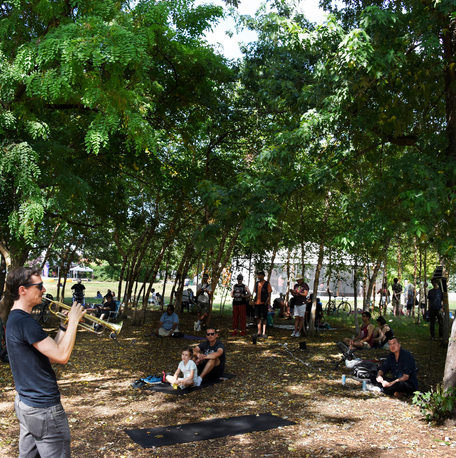 Audience listening to the premiere of Trumpet: Echoes at Socrates Sculpture Park